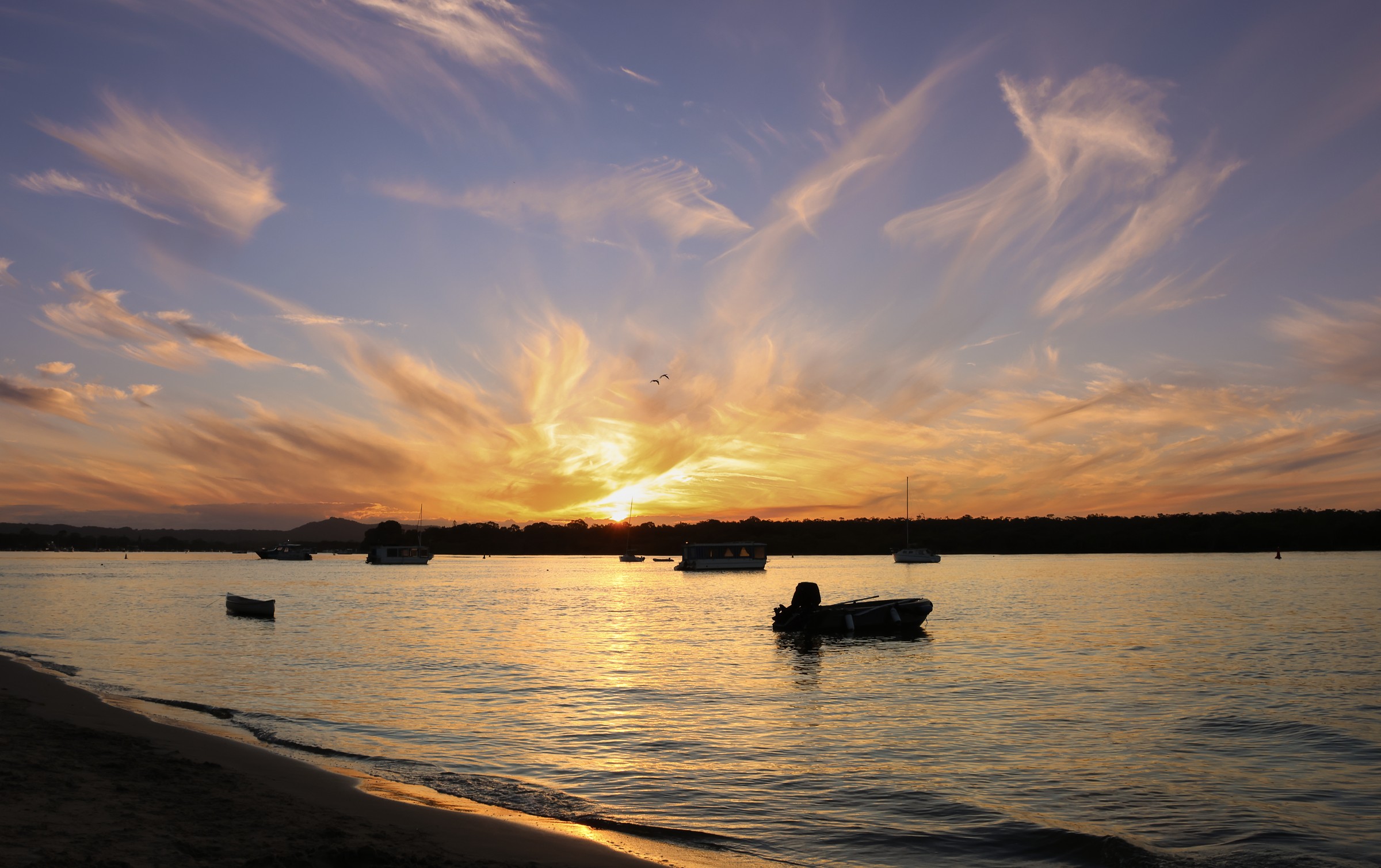 Noosa River as the sun sets over boats
